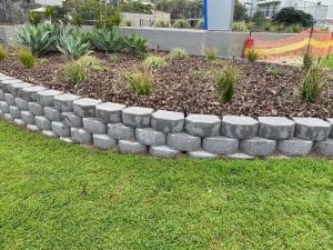 A dry stacked concrete block wall makes the perfect retaining wall diy project.