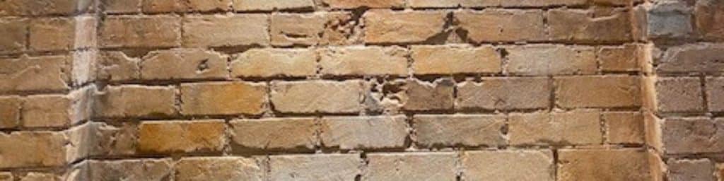 Building a retaining wall with bricks is best left to the professionals but can often match existing structures on your property.